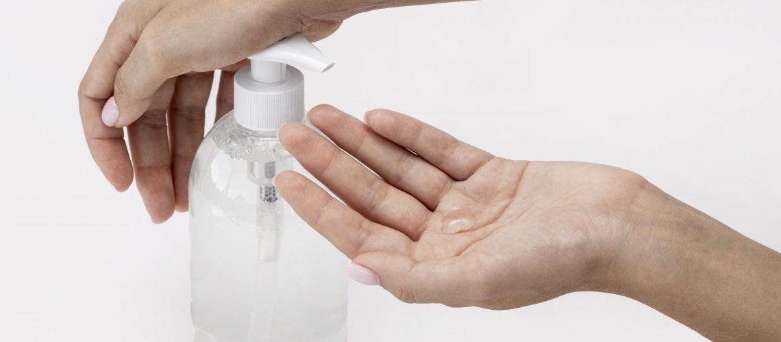 high-angle-person-using-liquid-soap